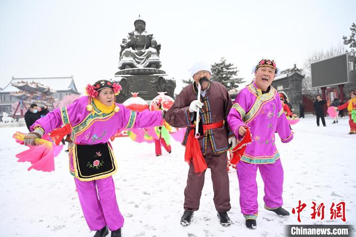 2月13日，秧歌隊在呼和浩特市大召廣場雪中起舞?！⑽娜A 攝