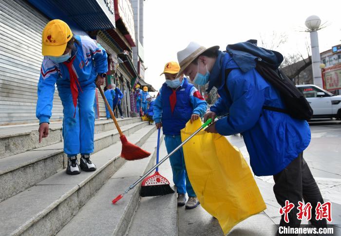 圖為拉薩市小學(xué)生打掃街道?！∝暩聛硭?攝