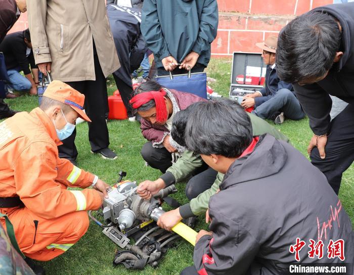 圖為森林消防員為護(hù)林員講解滅火裝備的使用方法。　昌都市森林消防支隊(duì) 供圖